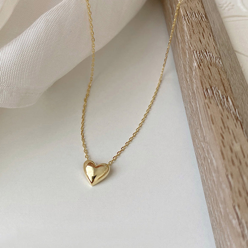 Side view of the 925 Silver-Plated 14K Gold Love Pendant Necklace highlighting the pendant's profile and thickness.