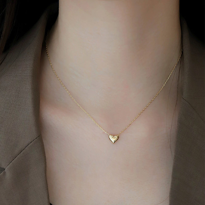 Model wearing the 925 Silver-Plated 14K Gold Love Pendant Necklace, demonstrating its elegant look in a real-life setting.
