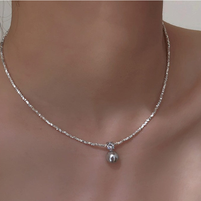  Model wearing the 925 shredded silver chain with natural pearl pendant necklace, illustrating how it complements both casual and formal outfits