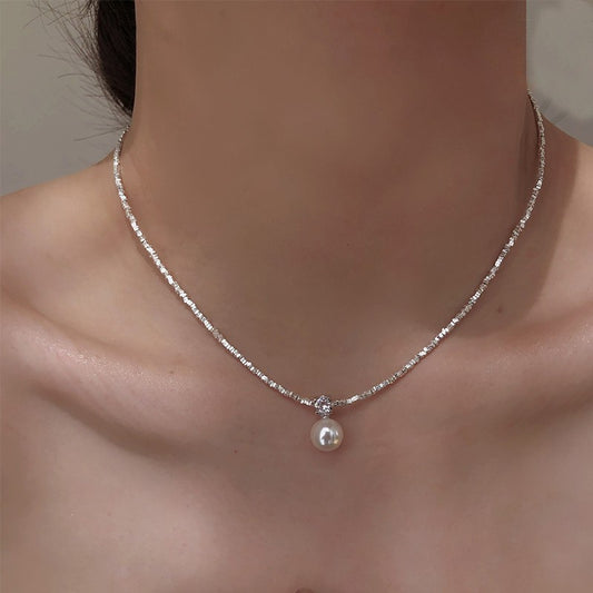  Model wearing the 925 shredded silver chain with natural pearl pendant necklace, illustrating how it complements both casual and formal outfits.