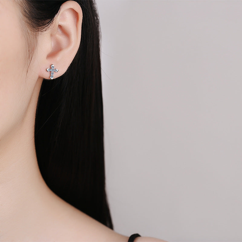 The 925 Silver Moissanite Cross Earrings worn by a model, illustrating their elegant style and how they complement various outfits