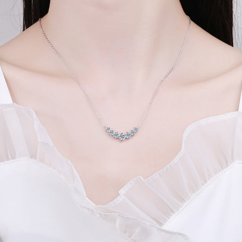  Model wearing the 925 silver inlaid seven moissanite pendant necklace, illustrating its elegance and stunning appearance in a real-life setting.