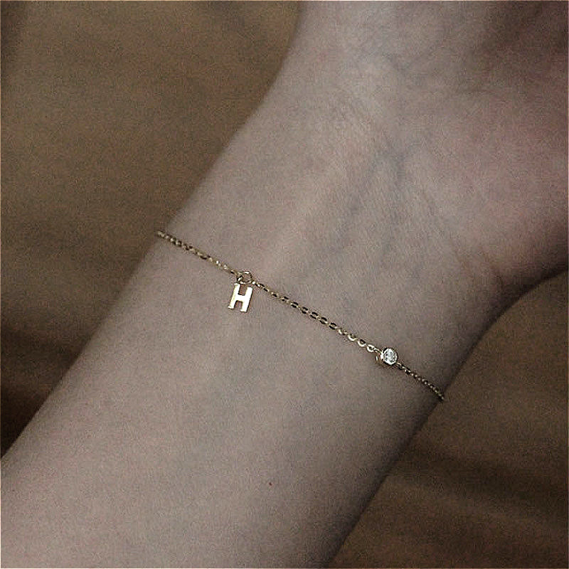  The 925 Silver-Plated K Gold H Letter Pendant Bracelet worn on a wrist, illustrating its elegant style and perfect fit for any occasion