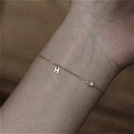  The 925 Silver-Plated K Gold H Letter Pendant Bracelet worn on a wrist, illustrating its elegant style and perfect fit for any occasion