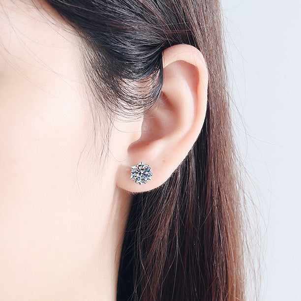 Model wearing 925 silver snowflake moissanite stud earrings, demonstrating their elegant style and how they complement winter outfits.