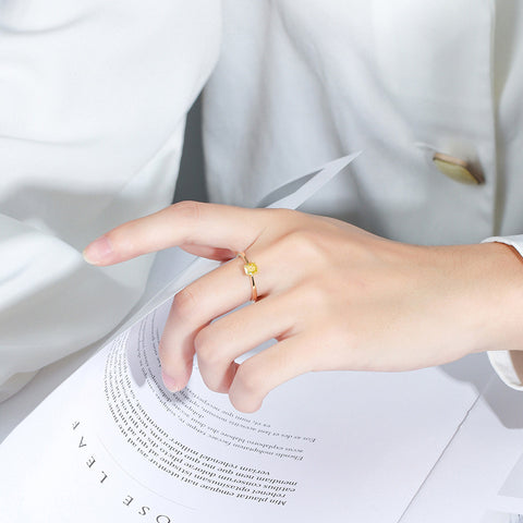 A model wearing the 925 silver yellow zircon ring, demonstrating its stylish look and how it complements various outfits.