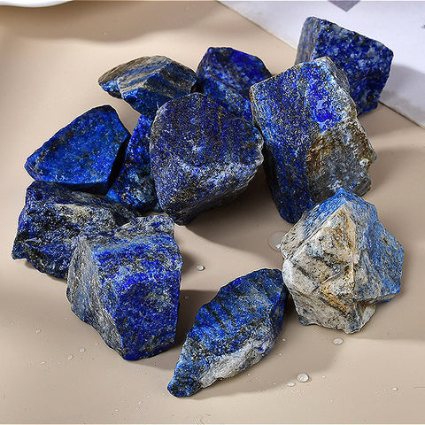 A detailed shot of natural rough lapis lazuli, focusing on the intricate patterns and textures, including golden pyrite inclusions, that reveal the stone's unique character and mineral composition.