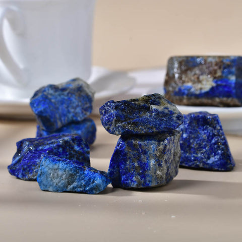 A side profile of a natural rough lapis lazuli stone, highlighting its irregular shape and the contrast between the vibrant blue surface and the rough edges, demonstrating its natural form.