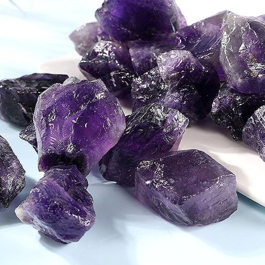  Close-up detail of the Natural Amethyst Rough Stone, focusing on the intricate crystal structures and the rich hue of the amethyst, perfect for enhancing energy.
