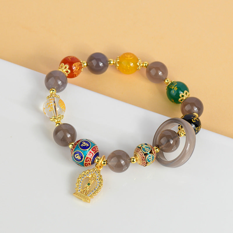  Close-up detail of the Five-way God of Wealth Bracelet, focusing on the texture of the agate beads and the sparkling finish of the colored diamond pestle pendant.