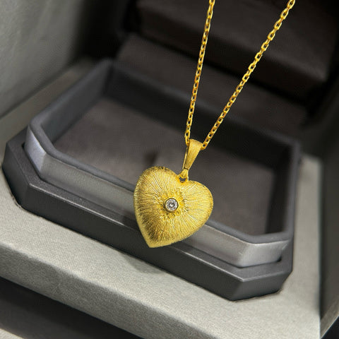  Detailed front view of the 925 silver heart pendant necklace with gold plating and diamond accent.