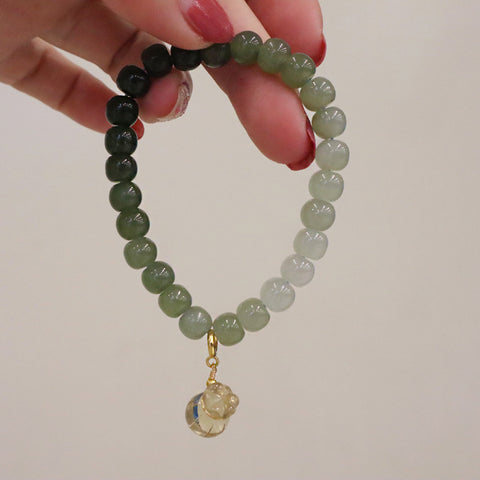  Hetian Jade Gradient Bracelet with Lemon Quartz Charm displayed hanging, emphasizing the charm’s details and jade bead gradient