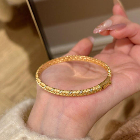 Model wearing a gold-plated wheat design cuff bracelet with sparkling zircon stones.