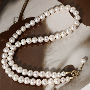 Front view of a handmade natural freshwater pearl necklace showcasing its elegant design and lustrous pearls.
