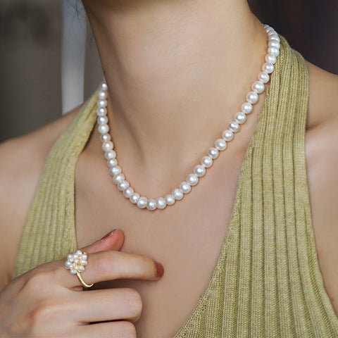 Model wearing a handmade natural freshwater pearl necklace, demonstrating its graceful fit and style.