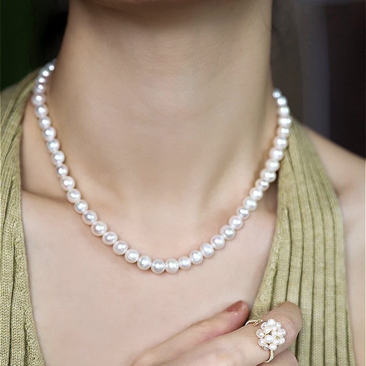 Model wearing a handmade natural freshwater pearl necklace, demonstrating its graceful fit and style