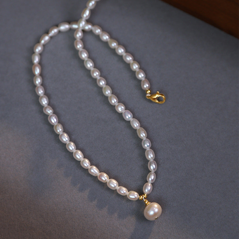  Close-up detail of the natural freshwater pearl pendant necklace, emphasizing the unique luster and texture of the pearl.