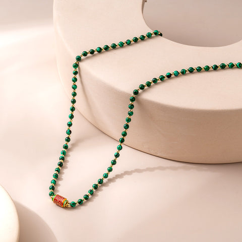 Close-up detail of the Natural Malachite Bead Necklace, showcasing the intricate swirls and textures of the malachite beads, emphasizing their unique beauty and craftsmanship.