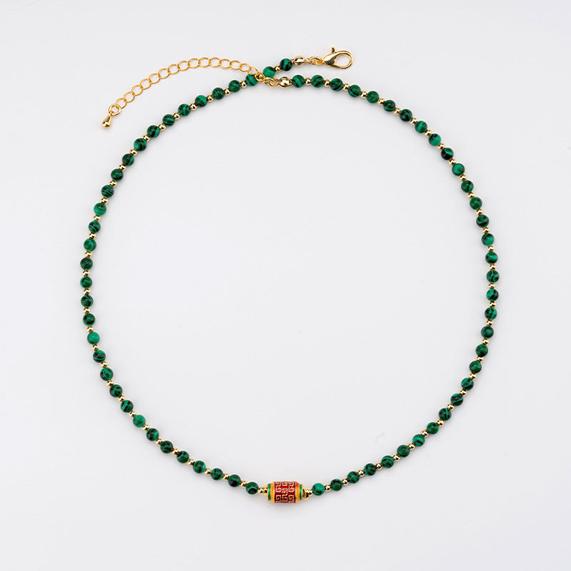  Front view of the Natural Malachite Bead Necklace, featuring vibrant green beads with striking banding patterns, symbolizing transformation and healing.
