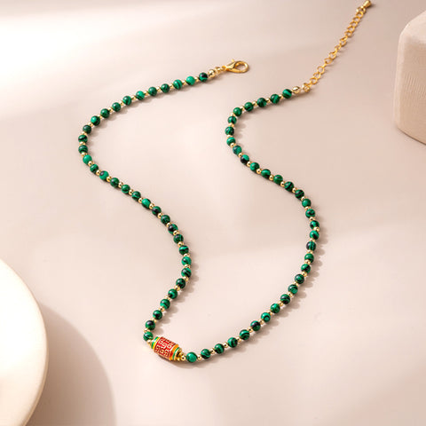 Side view of the Natural Malachite Bead Necklace, highlighting the smooth, polished finish of each bead and the overall fluidity of the design.