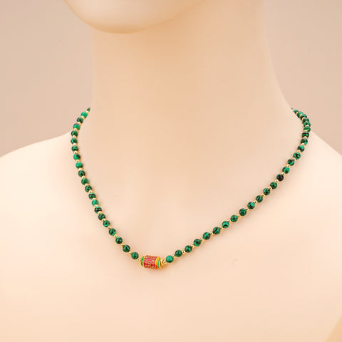  Image of the Natural Malachite Bead Necklace being worn, illustrating its elegant drape and the way it enhances the wearer’s style while promoting positive energy.