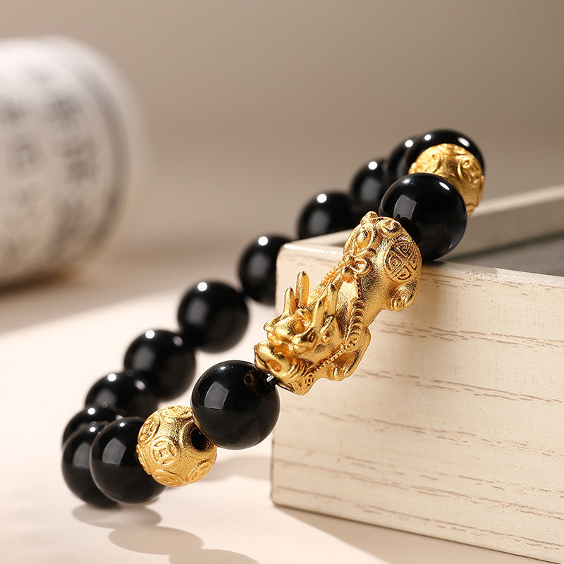 Side view of the Natural Obsidian Pixiu Bracelet, highlighting the smoothness of the beads and the detailed craftsmanship of the Pixiu, emphasizing its powerful Feng Shui properties.
