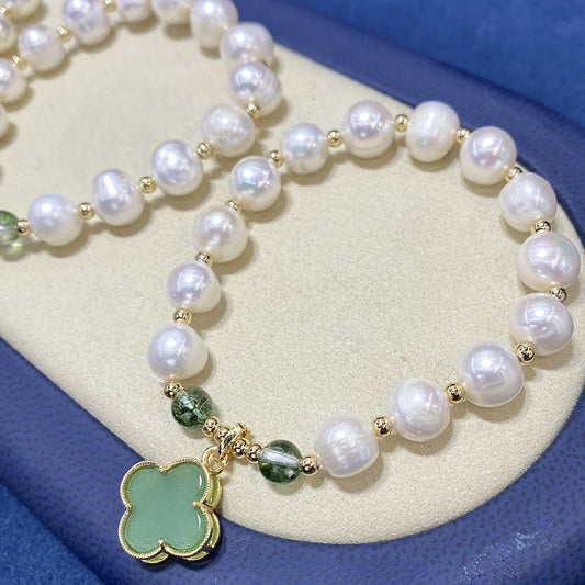 Side view of the natural pearl and green shell four-leaf clover bracelet, highlighting the smooth contours and craftsmanship.