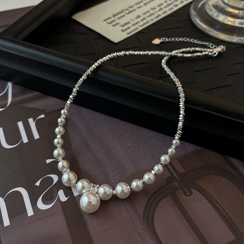 Side view of the Nova Belle natural freshwater pearl broken silver necklace, highlighting the intricate arrangement of pearls and silver accents.