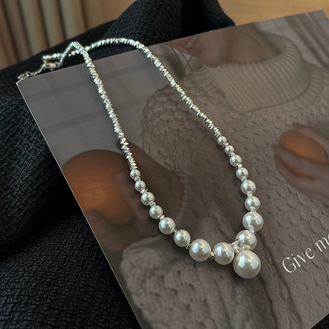 Side view of the Nova Belle natural freshwater pearl broken silver necklace, highlighting the intricate arrangement of pearls and silver accents.