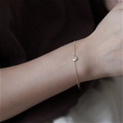  Model wearing the Nova Belle 925 silver-plated K-gold small crescent pendant bracelet, illustrating its elegant look and fit on the wrist.