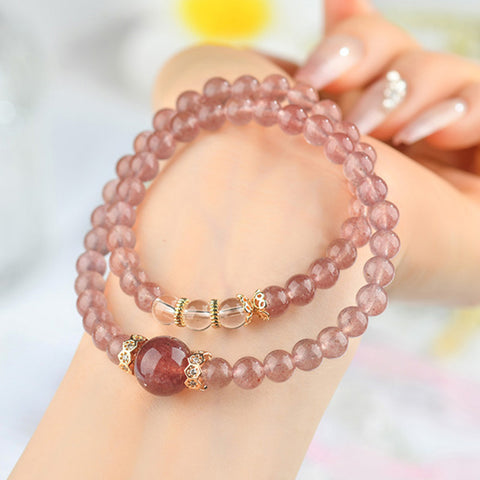  Model wearing the Peach Pink Natural Strawberry Crystal, White Crystal, and Garnet Double Bracelet, demonstrating its stylish look and how it enhances any outfit.